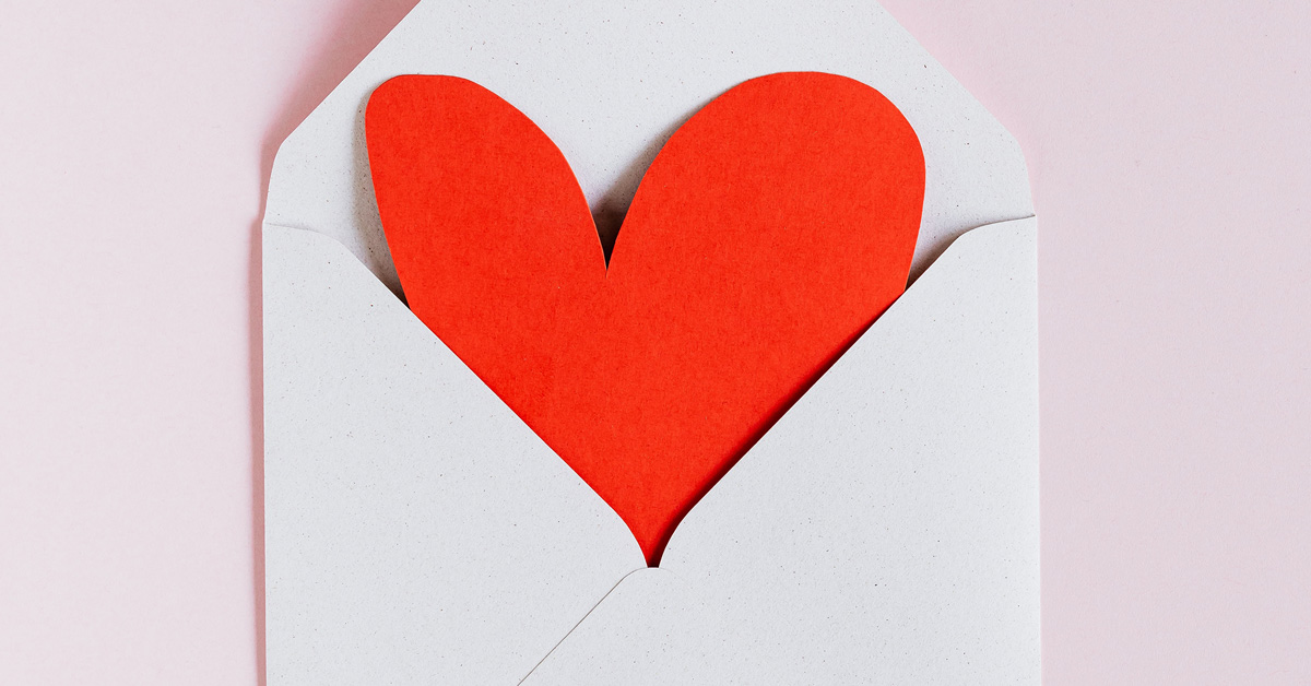 Open envelope with a red paper heart inside